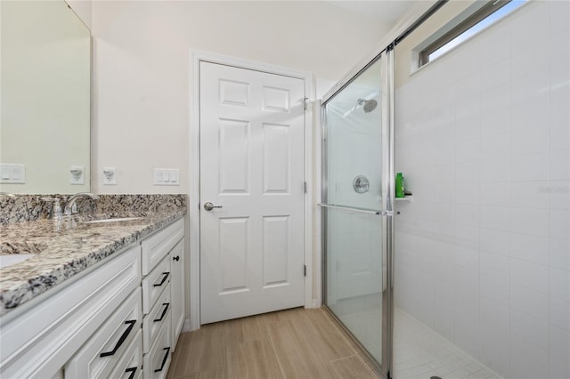 503 Vigo St, Davenport, FL 33837 - bathroom with tiled shower, double vanity, and wood finished floors