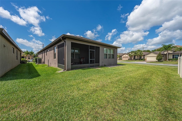 503 Vigo St, Davenport, FL 33837 - rear view of house with a lawn, a residential view, stucco siding, and cooling unit