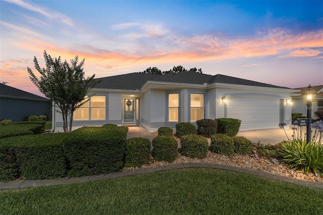 3393 Talley Ridge Dr, The Villages, FL 32162 - ranch-style house with an attached garage, stucco siding, concrete driveway, a lawn, and roof with shingles