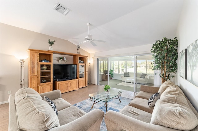 3393 Talley Ridge Dr, The Villages, FL 32162 - living room featuring vaulted ceiling, ceiling fan, and light wood-style flooring