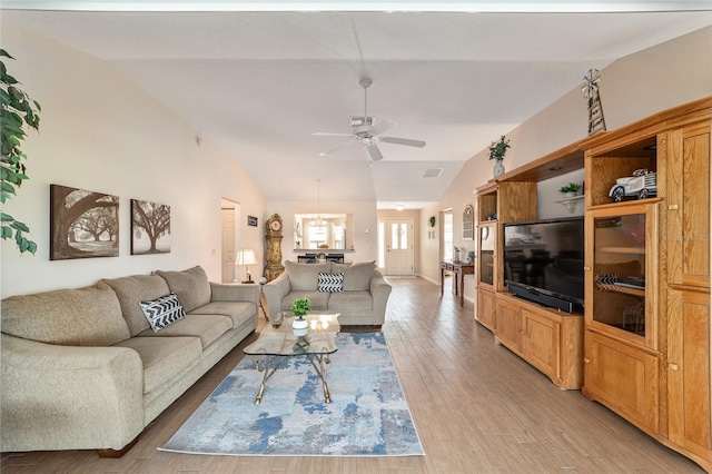 3393 Talley Ridge Dr, The Villages, FL 32162 - living area with lofted ceiling, a ceiling fan, and light wood-type flooring
