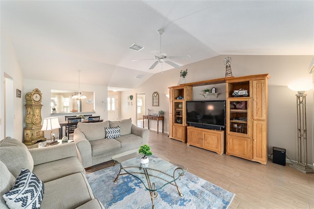 3393 Talley Ridge Dr, The Villages, FL 32162 - living area with lofted ceiling, light wood-style flooring, ceiling fan, a chandelier, and baseboards