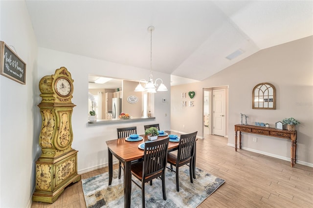 3393 Talley Ridge Dr, The Villages, FL 32162 - dining space with vaulted ceiling, light wood-style flooring, a chandelier, and baseboards