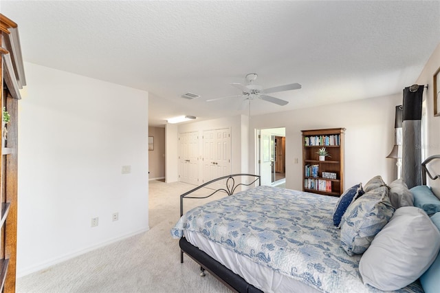 3393 Talley Ridge Dr, The Villages, FL 32162 - bedroom with light colored carpet, baseboards, a ceiling fan, a closet, and a textured ceiling