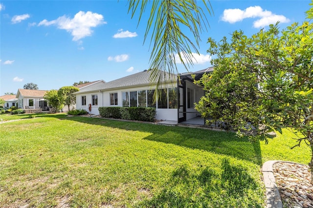 3393 Talley Ridge Dr, The Villages, FL 32162 - view of front of house with a front yard, stucco siding, and a sunroom
