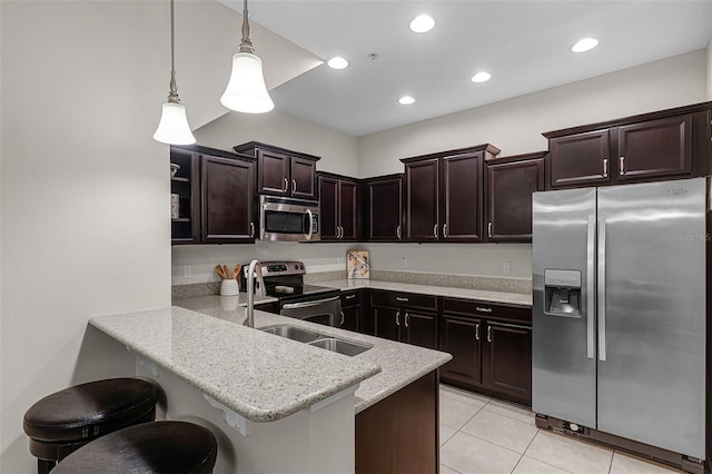 14430 Desert Haven St Unit 4302, Windermere, FL 34786 - kitchen with stainless steel appliances, dark brown cabinetry, a peninsula, decorative light fixtures, and light tile patterned floors