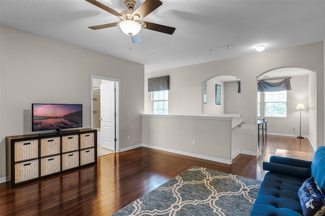 14430 Desert Haven St Unit 4302, Windermere, FL 34786 - living area featuring wood finished floors, arched walkways, a ceiling fan, and plenty of natural light