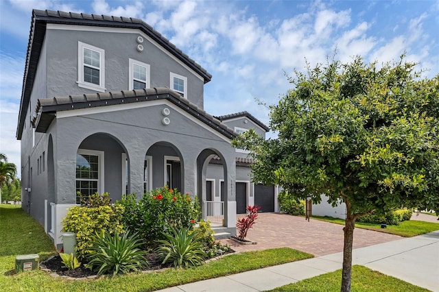 14513 Winter Stay Dr, Winter Garden, FL 34787 - mediterranean / spanish-style home with decorative driveway, covered porch, stucco siding, and a tiled roof