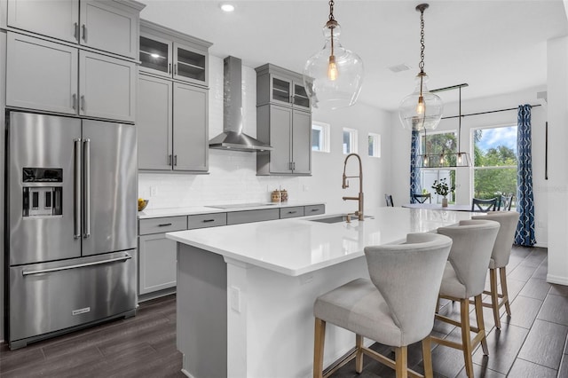 14513 Winter Stay Dr, Winter Garden, FL 34787 - kitchen featuring high end fridge, a sink, wall chimney exhaust hood, gray cabinets, and recessed lighting