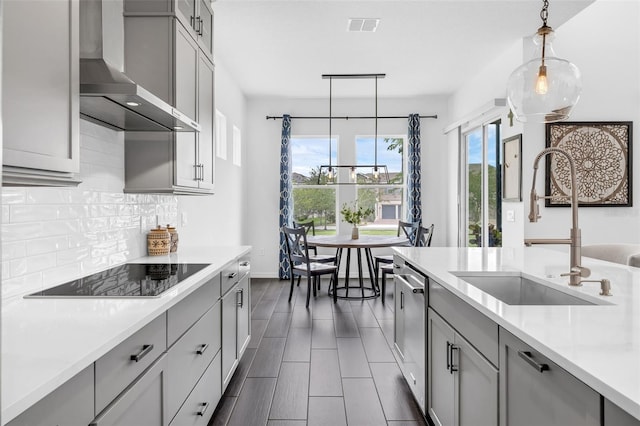 14513 Winter Stay Dr, Winter Garden, FL 34787 - kitchen with wall chimney exhaust hood, black electric stovetop, a sink, gray cabinetry, and backsplash
