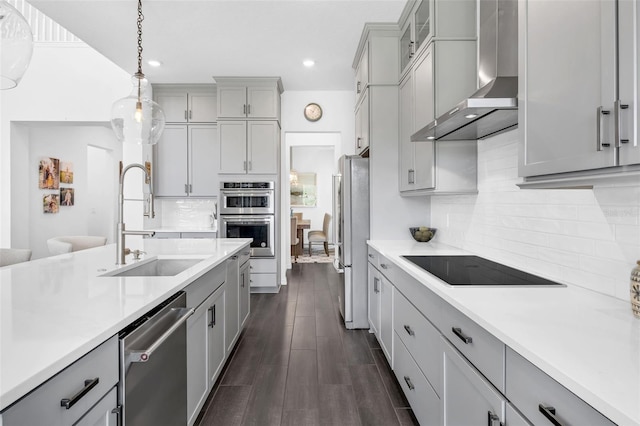 14513 Winter Stay Dr, Winter Garden, FL 34787 - kitchen with a sink, wall chimney exhaust hood, stainless steel appliances, gray cabinetry, and light countertops