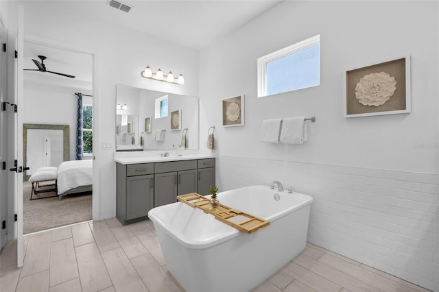 14513 Winter Stay Dr, Winter Garden, FL 34787 - full bath featuring a ceiling fan, a freestanding tub, connected bathroom, vanity, and wainscoting