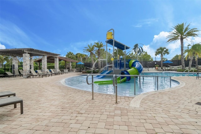 14513 Winter Stay Dr, Winter Garden, FL 34787 - community pool with a water slide, a water play area, fence, a pergola, and a patio