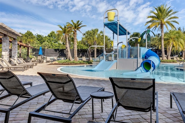14513 Winter Stay Dr, Winter Garden, FL 34787 - community pool with a water slide, a patio area, and a water play area