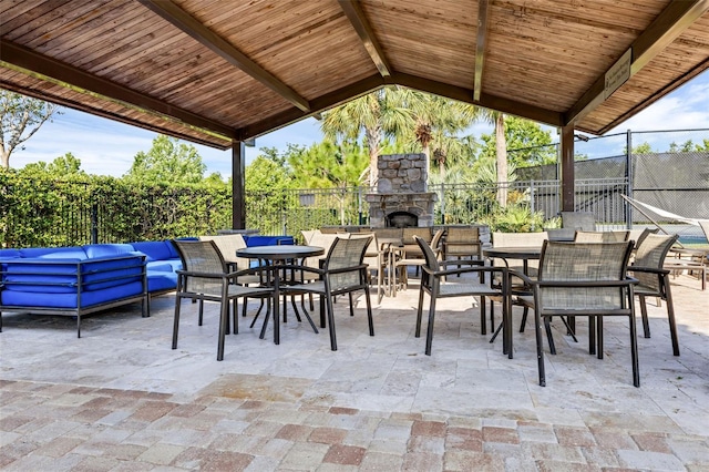 14513 Winter Stay Dr, Winter Garden, FL 34787 - fenced backyard featuring an outdoor living space with a fireplace, a patio, and outdoor dining space