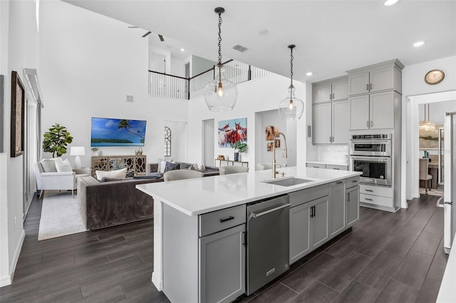 14513 Winter Stay Dr, Winter Garden, FL 34787 - kitchen featuring appliances with stainless steel finishes, gray cabinets, light countertops, a sink, and a high ceiling
