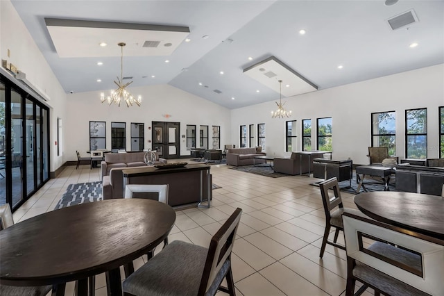 14513 Winter Stay Dr, Winter Garden, FL 34787 - dining area with a chandelier, light tile patterned floors, high vaulted ceiling, and recessed lighting