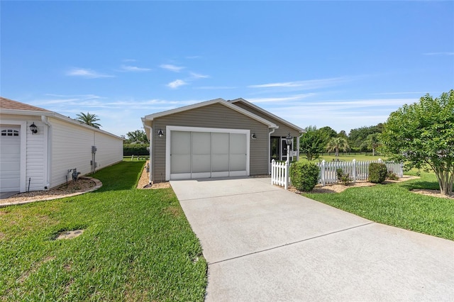 single story home with a detached garage and concrete driveway