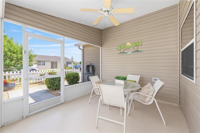 sunroom featuring ceiling fan and outdoor dining area