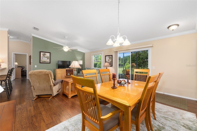 dining room featuring wood finished floors, vaulted ceiling, ornamental molding, a ceiling fan, and a chandelier