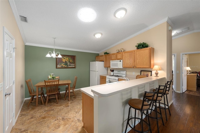 kitchen featuring white appliances, ornamental molding, a kitchen breakfast bar, light countertops, and baseboards