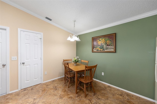 dining room featuring a chandelier, crown molding, lofted ceiling, a textured ceiling, and baseboards