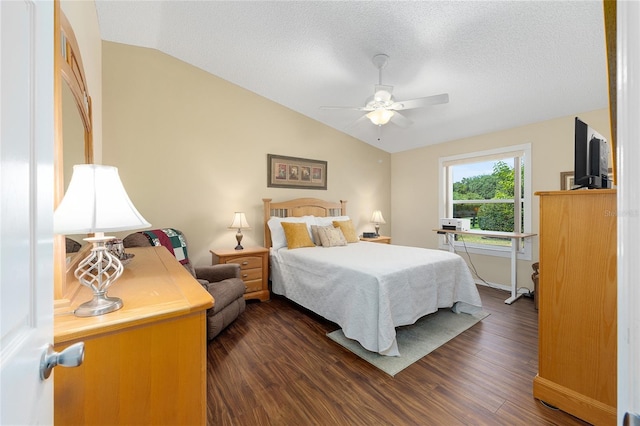 bedroom featuring vaulted ceiling, dark wood-type flooring, baseboards, a textured ceiling, and a ceiling fan