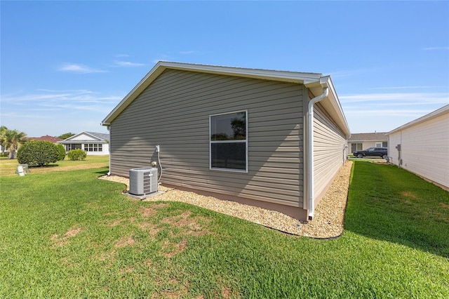 view of property exterior featuring a yard and central AC unit