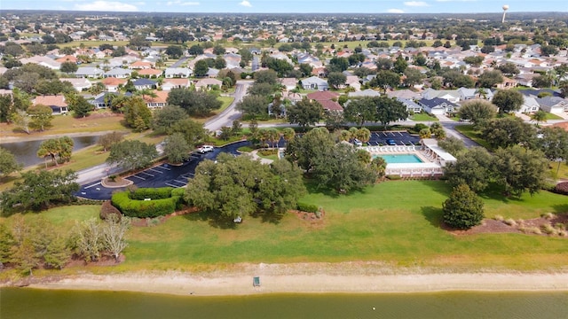 aerial view of property and surrounding area with a large body of water and a pool