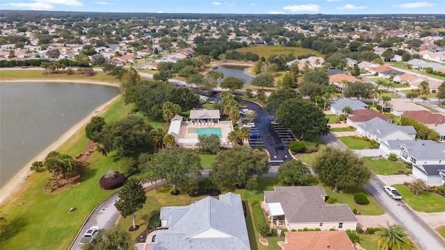 aerial view of property and surrounding area with a nearby body of water and nearby suburban area