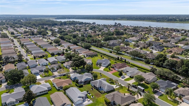 view of property location featuring a large body of water and nearby suburban area