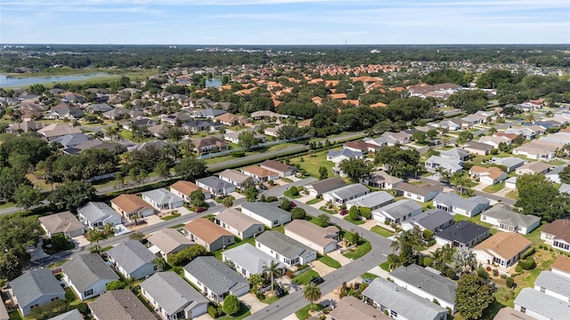 aerial view of property's location featuring a large body of water and nearby suburban area