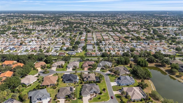 aerial view of property's location with a nearby body of water and nearby suburban area