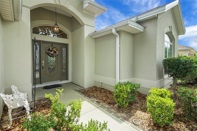 1828 Hollow Branch Way, The Villages, FL 32162 - doorway to property featuring stucco siding