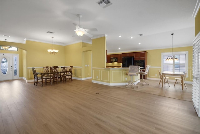 1828 Hollow Branch Way, The Villages, FL 32162 - living room featuring a chandelier, crown molding, light wood-type flooring, ceiling fan, and baseboards