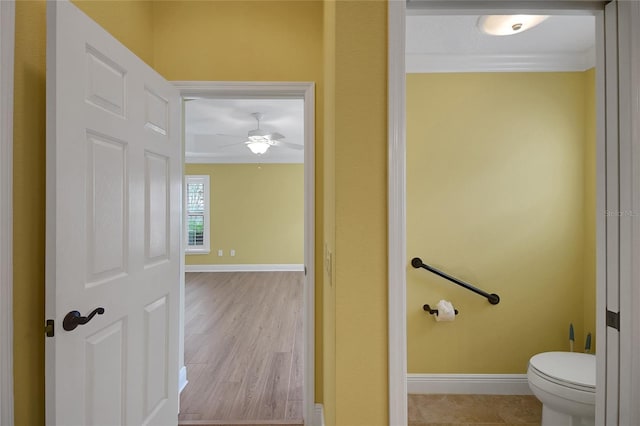 1828 Hollow Branch Way, The Villages, FL 32162 - bathroom with crown molding, baseboards, ceiling fan, toilet, and wood finished floors