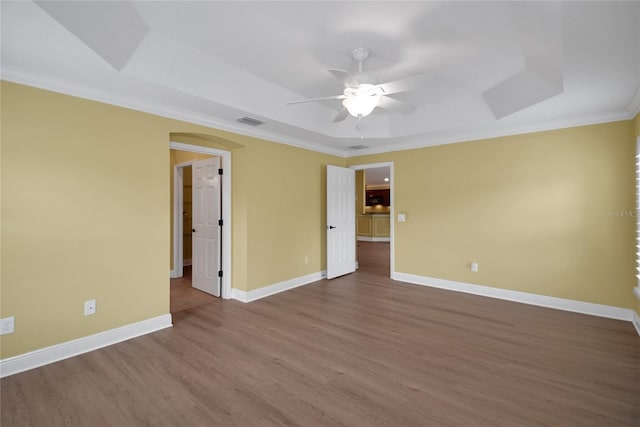 1828 Hollow Branch Way, The Villages, FL 32162 - empty room featuring a tray ceiling, ceiling fan, wood finished floors, ornamental molding, and baseboards