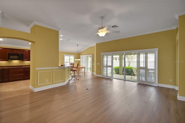 1828 Hollow Branch Way, The Villages, FL 32162 - living room with ceiling fan, light wood finished floors, ornamental molding, baseboards, and lofted ceiling