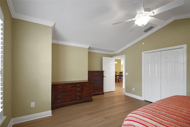 1828 Hollow Branch Way, The Villages, FL 32162 - bedroom with vaulted ceiling, wood finished floors, baseboards, a closet, and a ceiling fan