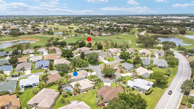 616 Hartford Ln, The Villages, FL 32162 - aerial overview of property's location with a large body of water, nearby suburban area, and a local golf course