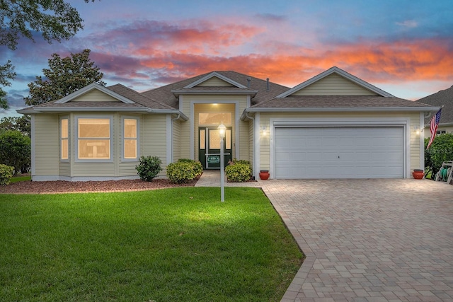 616 Hartford Ln, The Villages, FL 32162 - ranch-style house featuring an attached garage, decorative driveway, a front yard, and roof with shingles