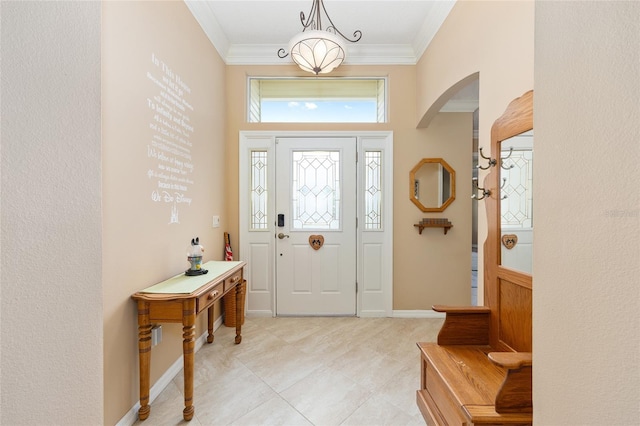 616 Hartford Ln, The Villages, FL 32162 - foyer entrance featuring arched walkways, ornamental molding, light tile patterned floors, and baseboards