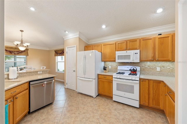 616 Hartford Ln, The Villages, FL 32162 - kitchen featuring white appliances, crown molding, a chandelier, backsplash, and light tile patterned floors
