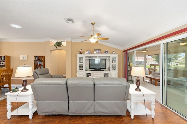 616 Hartford Ln, The Villages, FL 32162 - living room featuring a ceiling fan, ornamental molding, arched walkways, vaulted ceiling, and wood finished floors