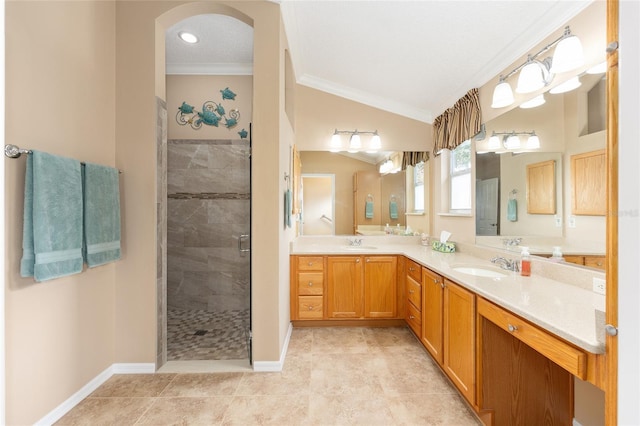 616 Hartford Ln, The Villages, FL 32162 - full bath with ornamental molding, a stall shower, double vanity, vaulted ceiling, and baseboards