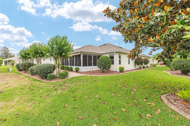 616 Hartford Ln, The Villages, FL 32162 - back of property with a sunroom and a yard