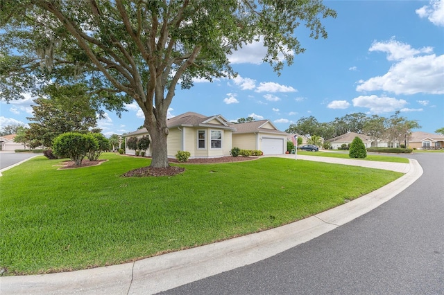 616 Hartford Ln, The Villages, FL 32162 - view of front of home with concrete driveway, a front yard, and an attached garage