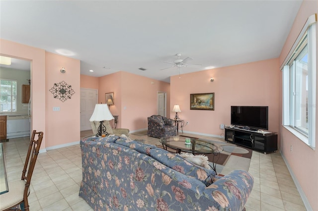 12687 SE 90th Ter, Summerfield, FL 34491 - living area featuring light tile patterned flooring, a ceiling fan, and baseboards