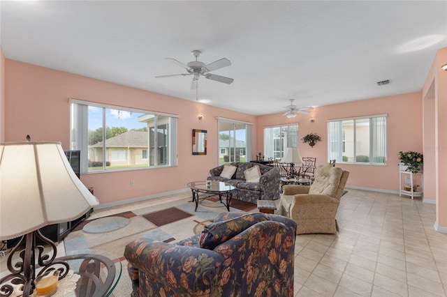 12687 SE 90th Ter, Summerfield, FL 34491 - living room featuring baseboards, ceiling fan, and light tile patterned flooring