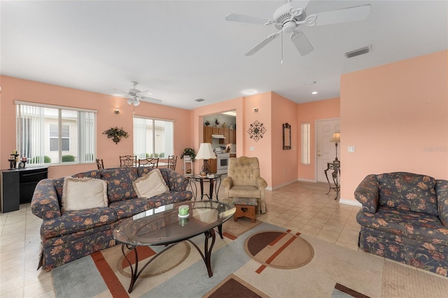 12687 SE 90th Ter, Summerfield, FL 34491 - living area with a ceiling fan, light tile patterned flooring, and baseboards